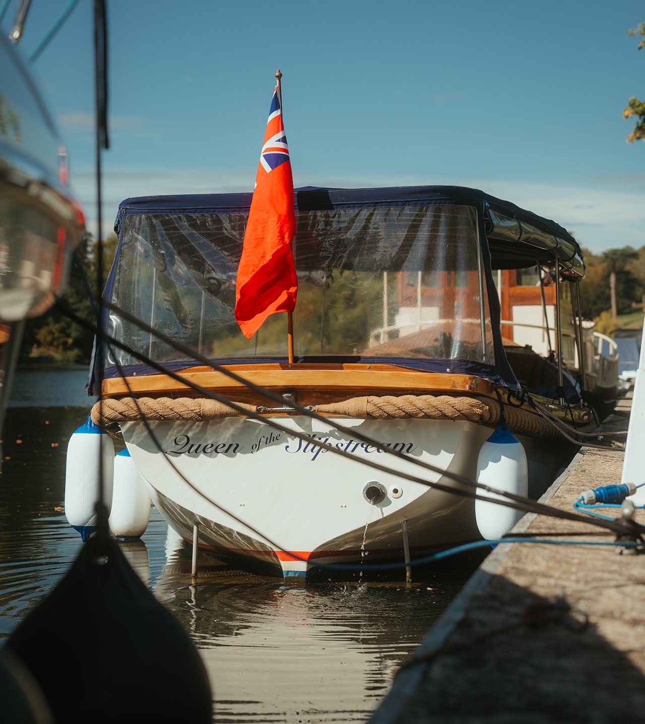 Queen of the Slipstream flying the red ensign at her mooring