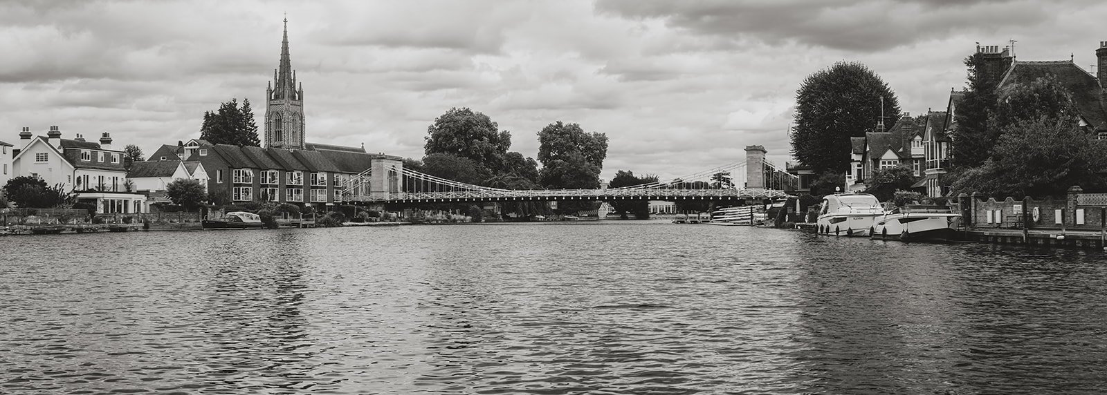 Marlow's All Saints Church and suspension bridge seen from the River Thames